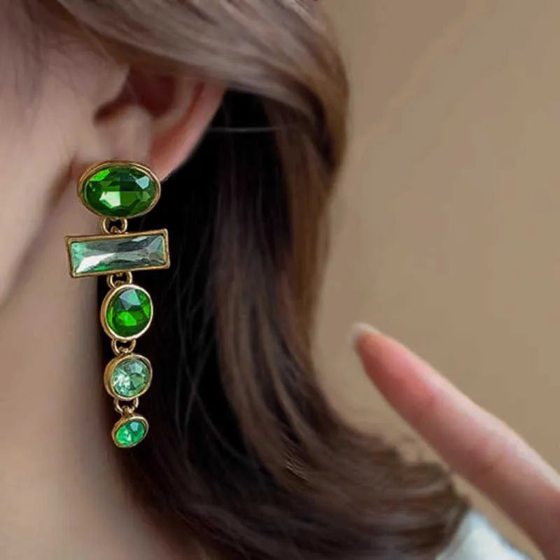 A pair of green gradient tassel earrings with geometric alloy settings and inlaid zircon stones.