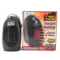 Black compact ceramic electric heater with digital display and rotating plug on a flat surface.