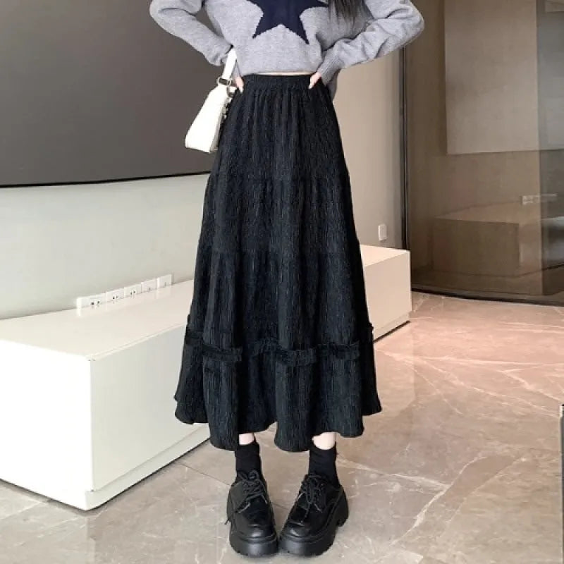 Korean urban style corduroy A-line midi skirt with elastic waistband in milky white colour on a hanger.