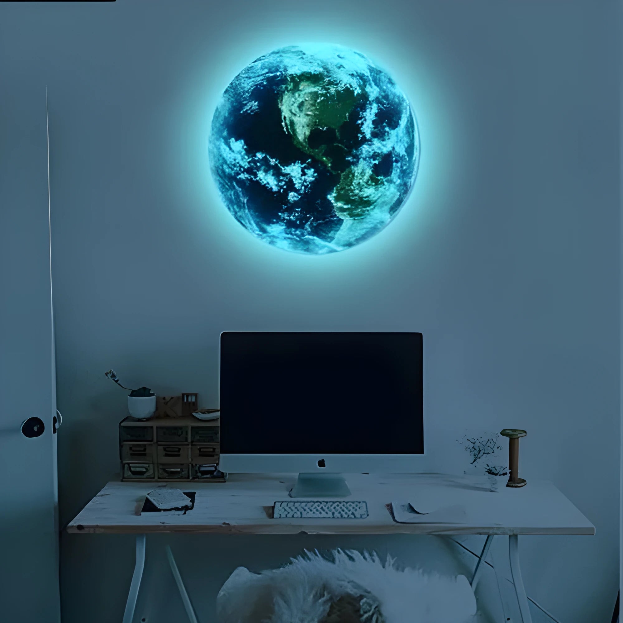Glow in the dark 3D Earth planet wall sticker in three size options on a wall.