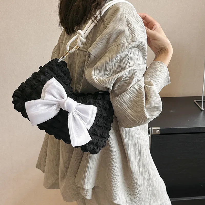 Women's casual canvas handbag with single shoulder strap in black, white, or pink colours showing sandwich pocket design