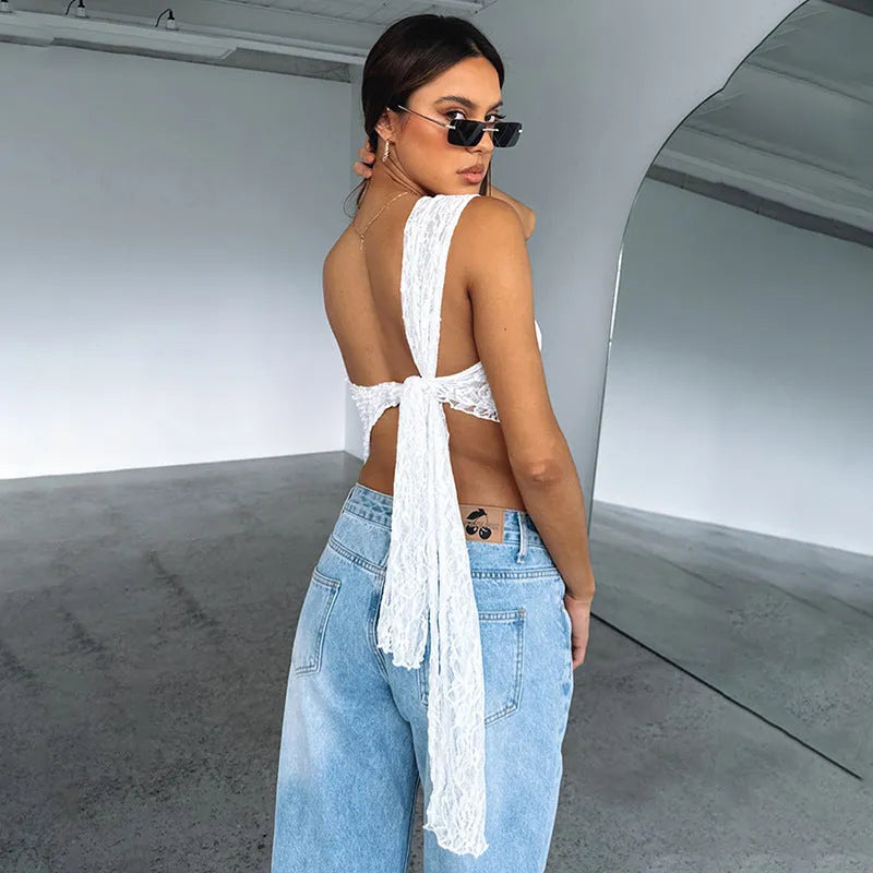Women's apricot lace backless sleeveless vest with asymmetrical neckline on a hanger.