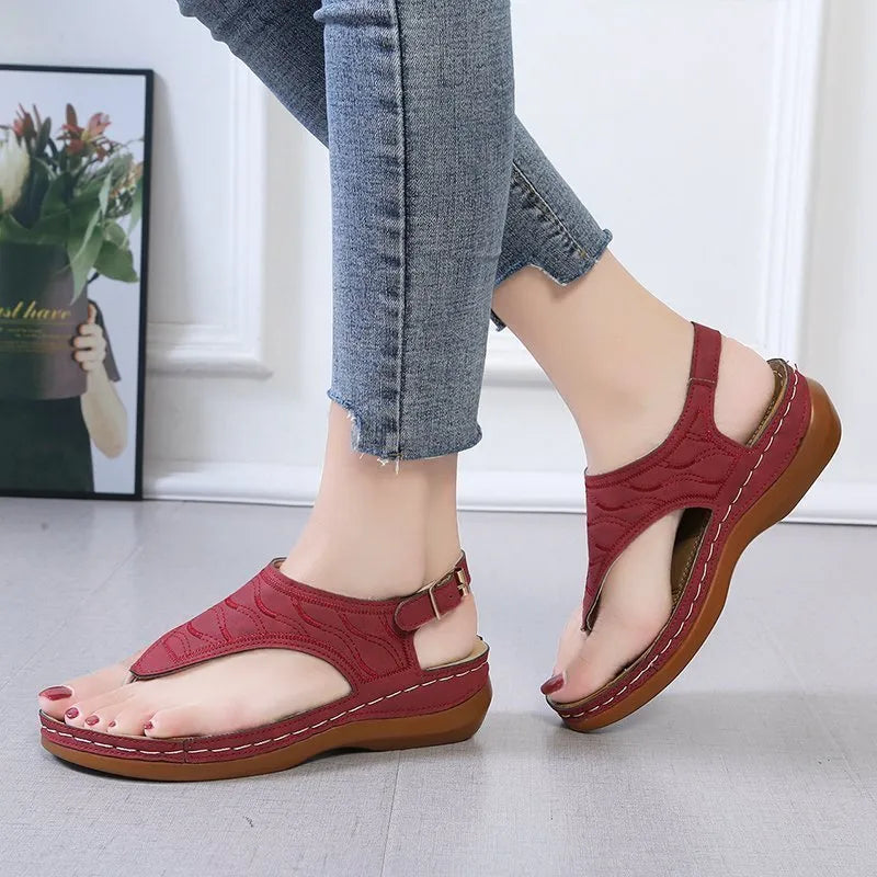 Women's casual wedge heel flip flop sandals with adjustable back strap in red vegan leather