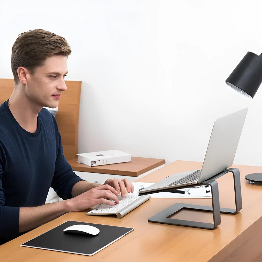 Black aluminium alloy laptop stand with 29.9 cm width on desktop
