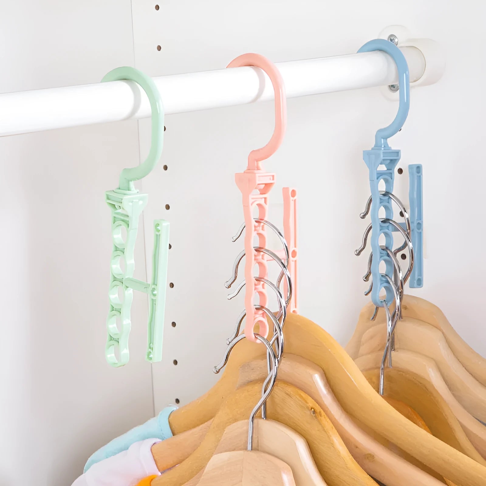 Blue revolving wardrobe hanger with five hooks and a central white handle for easy rotation
