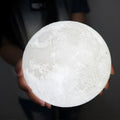 3D printed rechargeable moon lamp with touch ring control, shown in white and yellow light on a wooden holder.