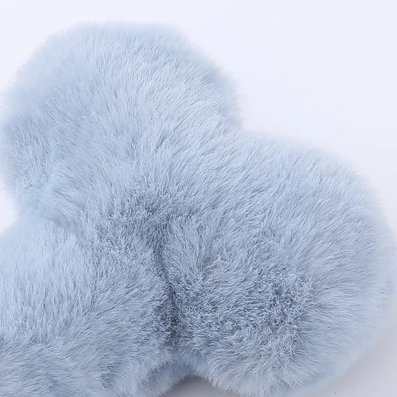 Plush bone-shaped dog toy in blue, pink or yellow with a squeaker for interactive chewing play.