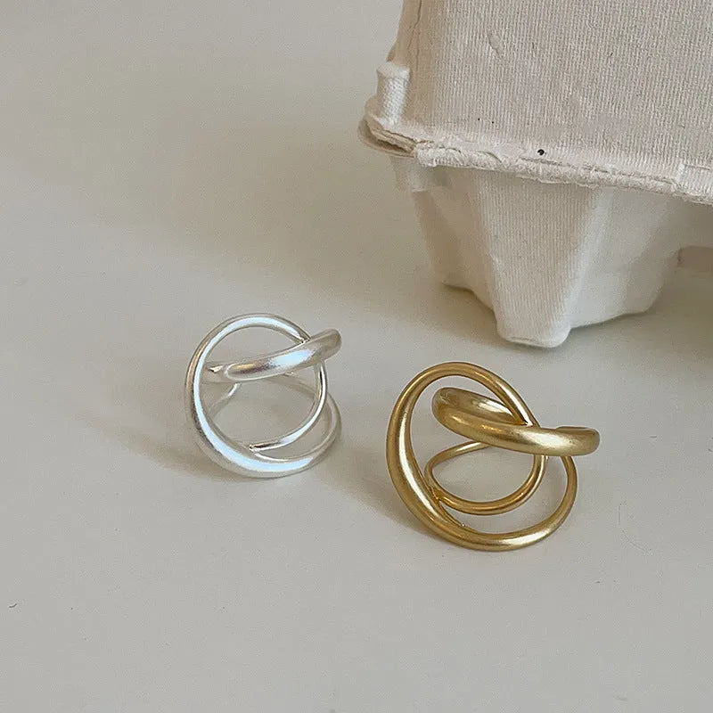 Three-dimensional interlaced geometric open ring in matte metal with gold plating