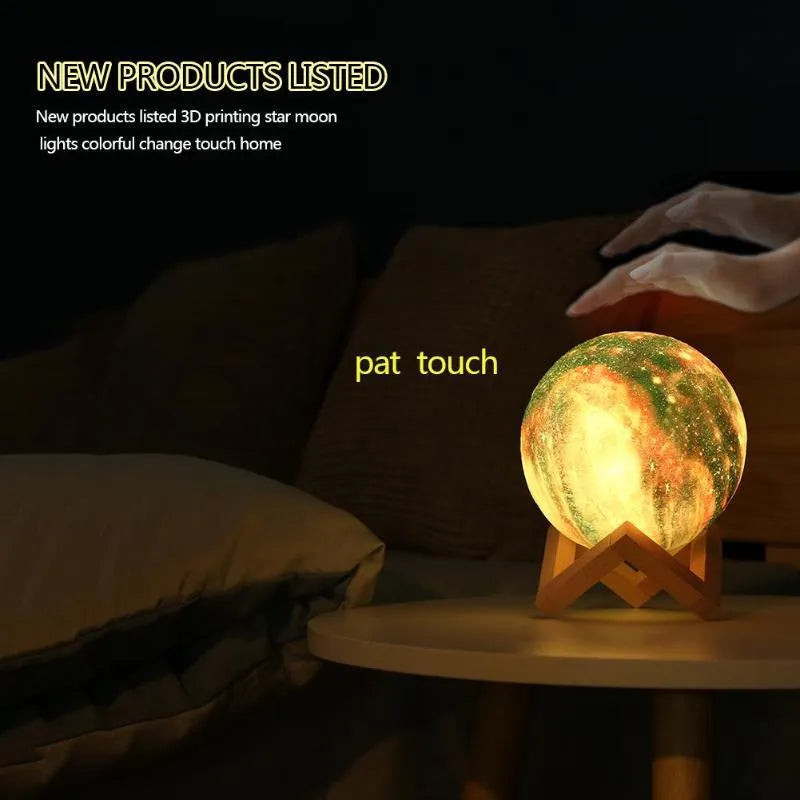 3D printed spherical lunar night light glowing with soft colour-changing LED light on a dark surface.