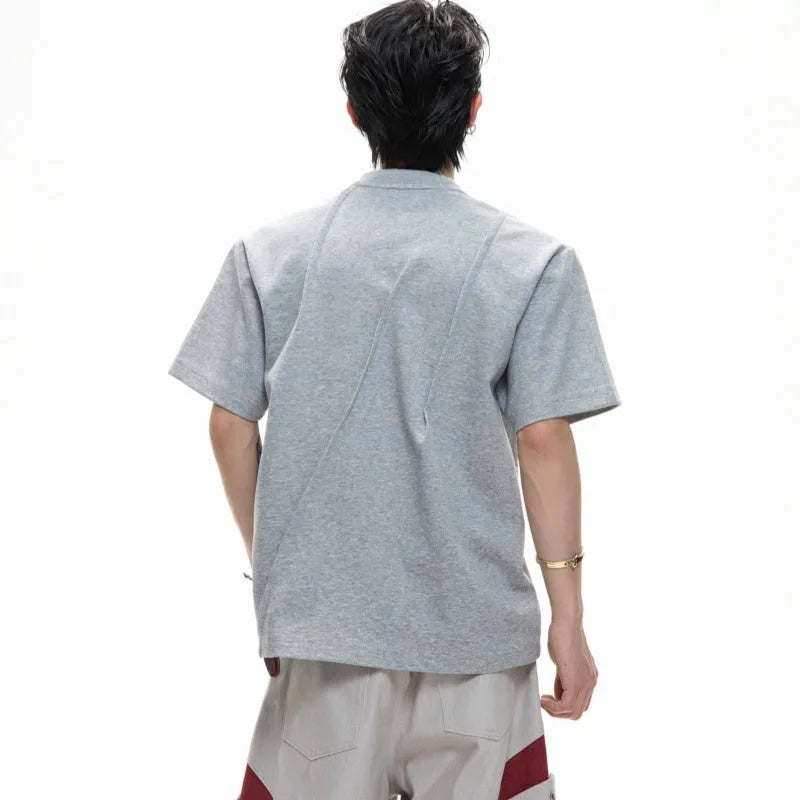 Men's loose grey cotton T-shirt with pleated detail and round neck.