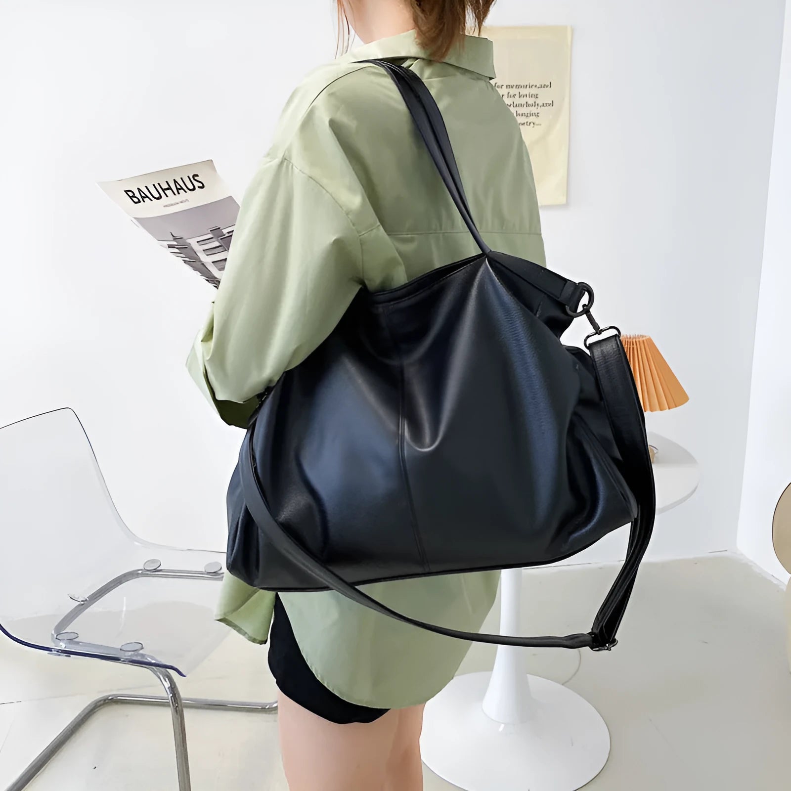 Large soft surface messenger bag showing horizontal square shape with adjustable shoulder strap and zip opening