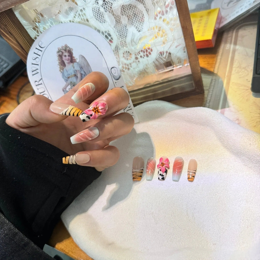 Embossed lily flower and leopard print zebra pattern nail art set showing dimensional texture and size variations