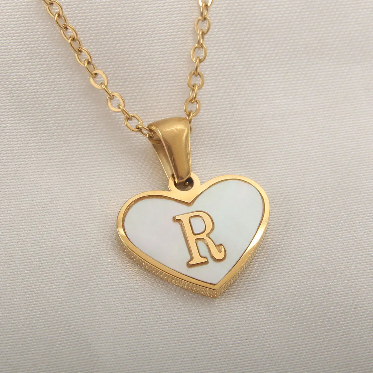 Gold heart necklace with white shell pendant and initial charm on 45cm adjustable chain