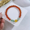 Handcrafted red agate bracelet with Chinese Dragon and Lucky Bag festival motifs