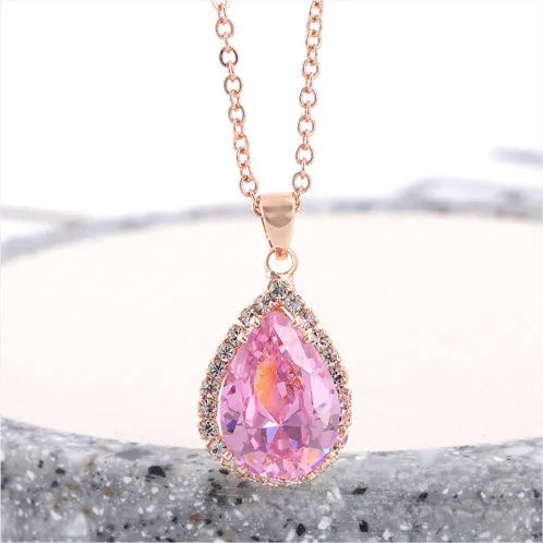 Women's pink rhinestone drop necklace with rose gold electroplated finish and geometric design