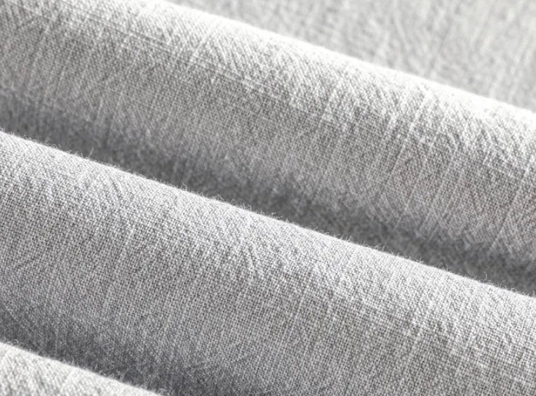A man's loose-fit linen casual shirt in a solid colour, shown in light grey, featuring long sleeves and a button front.