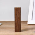 Black walnut wood portable power bank showing natural grain, with dimensions 100mm by 25mm.