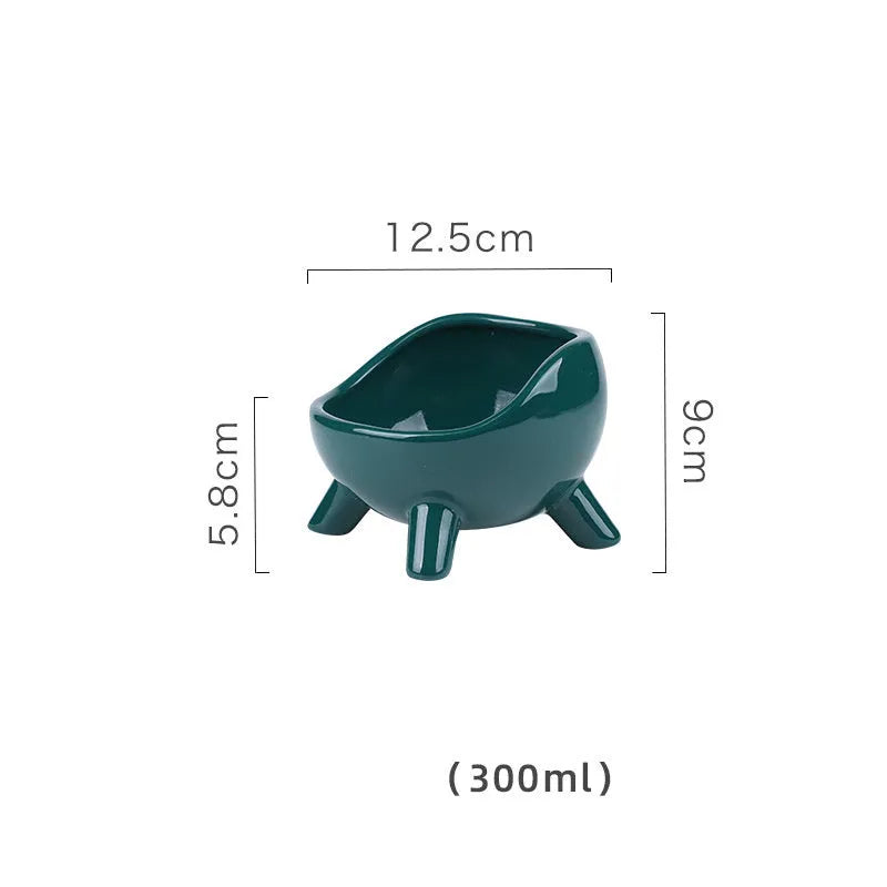 Green four-legged ceramic pet bowl for cats and small dogs on floor