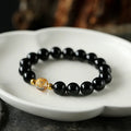 Geometric obsidian and white crystal bracelet with black agate beads and golden dragon centrepiece for 14-16cm wrists