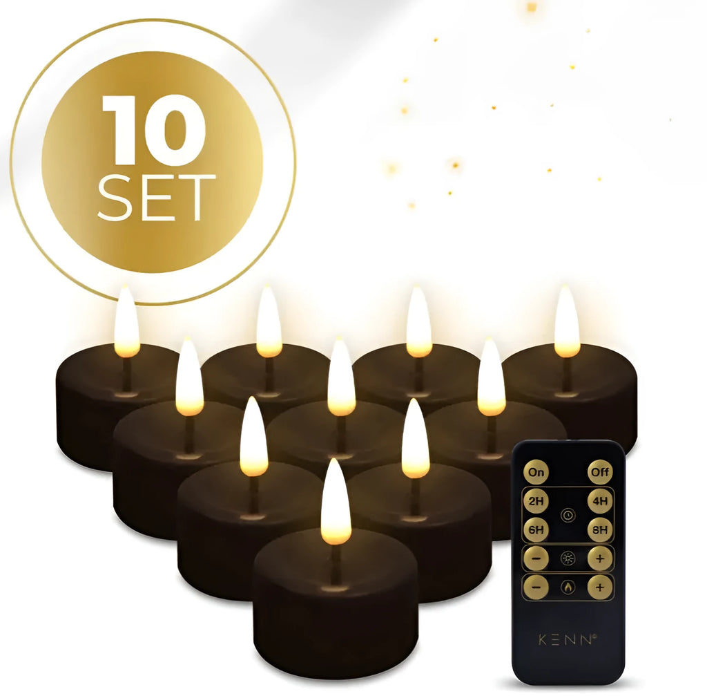 Set of four black flameless LED tealight candles showing flickering warm white glow.