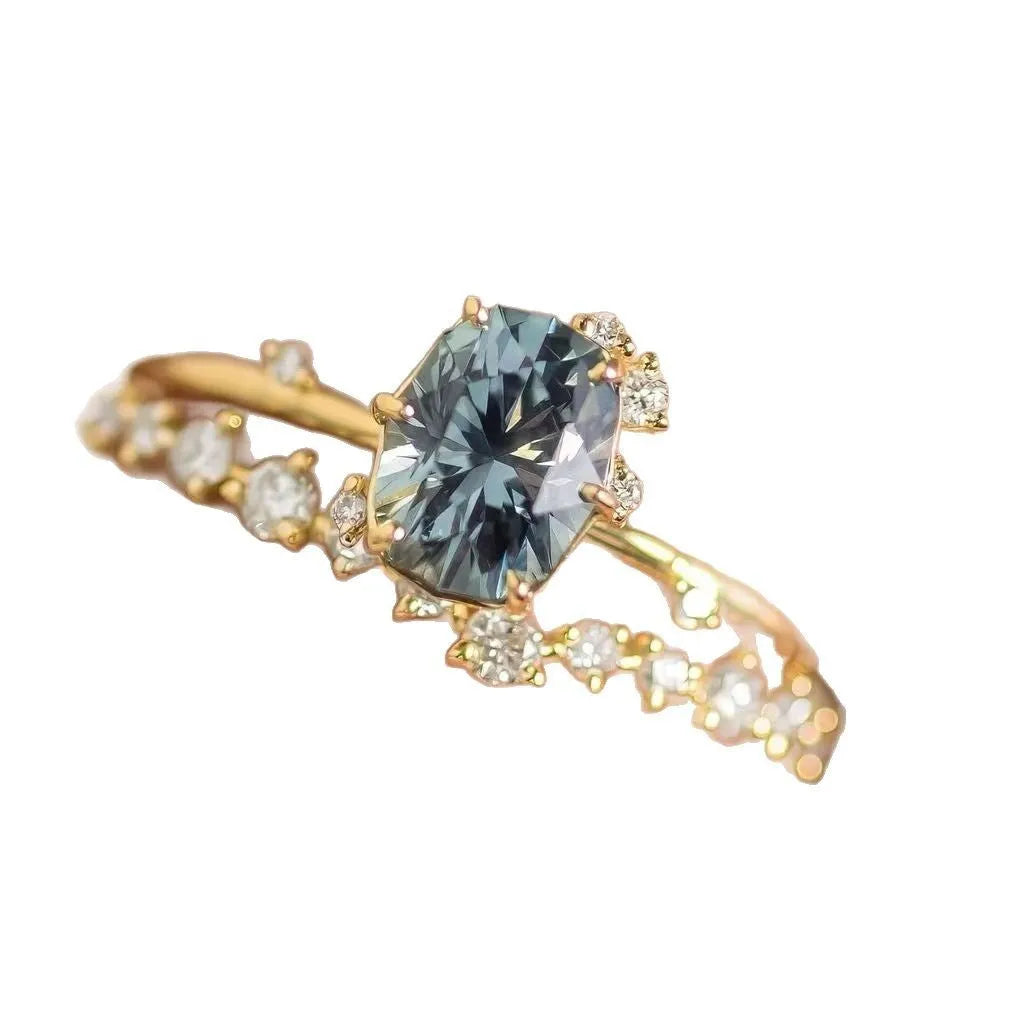 Gold plated women's ring with flower design and green zircon stones showing five available ring sizes
