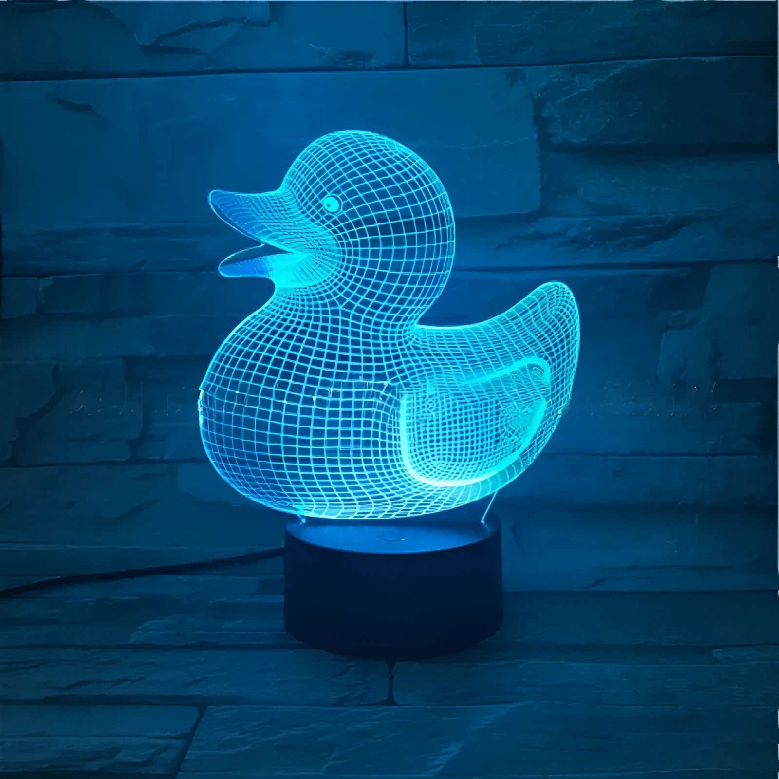 3D cartoon yellow duck LED night light on a table, showing multiple colour options with remote control.