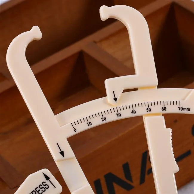 Acrylic body fat caliper skin fold thickness measuring instrument showing measurement scale