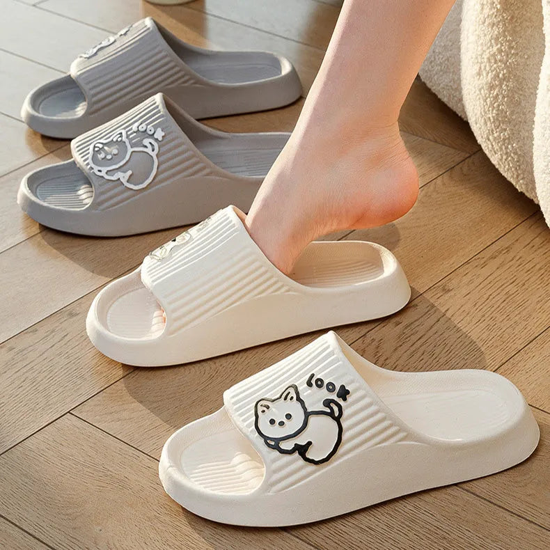 Women's green cat slippers with thick EVA platform sole on a wooden floor