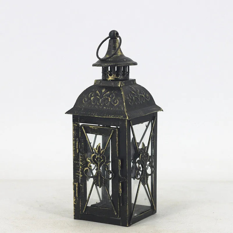 Black and white wrought iron floor-standing storm lantern with tempered glass in three sizes for courtyard use.