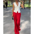 Women's beige two-piece set featuring a sleeveless deep V-neck top and high-waist wide-leg trousers.