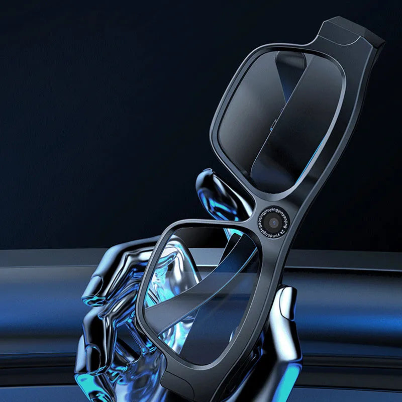 Black head-mounted smart Bluetooth glasses with a built-in camera for video recording on a table with accessories.