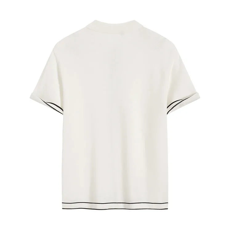 White short sleeve cardigan with dark contrast lapels on a hanger.