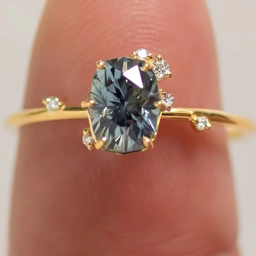 Gold plated women's ring with flower design and green zircon stones showing five available ring sizes