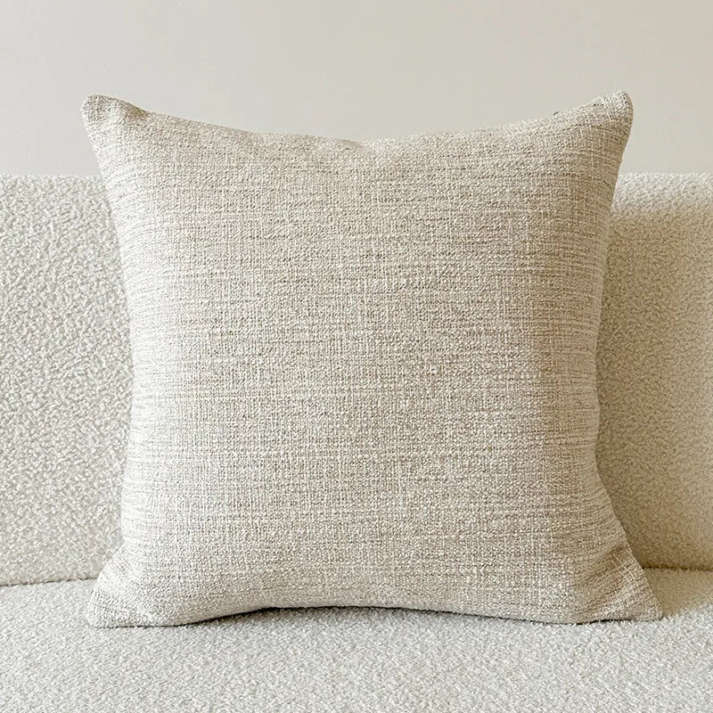 Amber paisley patterned jacquard sofa cushion cover on a sofa, showing textured fabric and plant motif.