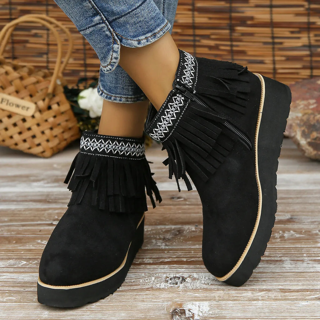 Women's black suede wedge ankle boots with side zipper and decorative tassel on a thick rubber sole.