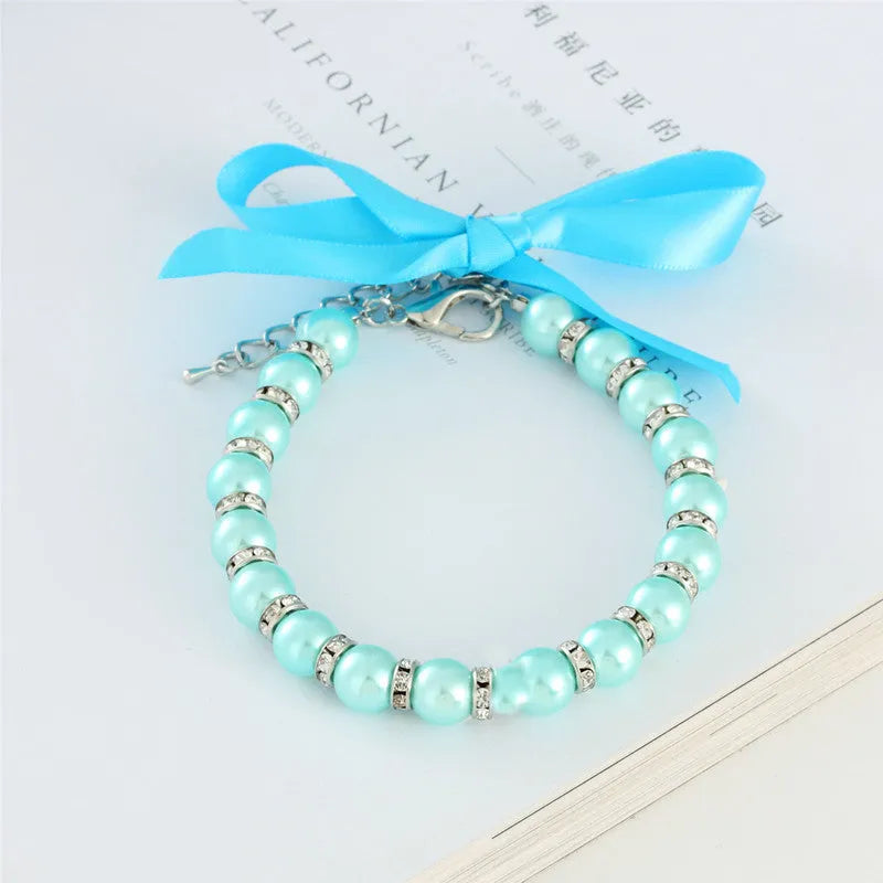Adjustable pearl and rhinestone dog necklace on a soft ribbon in blue colour
