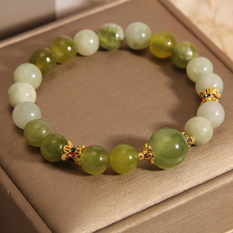 Original design women's bracelet made from green Xiuyan jade in a sweet mori style.