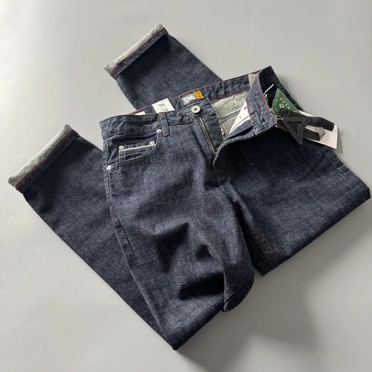 Men's primary blue straight-leg cotton denim trousers on a neutral background, showing mid-waist fit and trouser length.