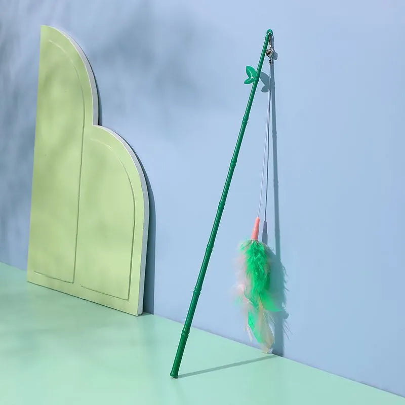Green interactive cat feather wand toy with bells and feathers on a durable string