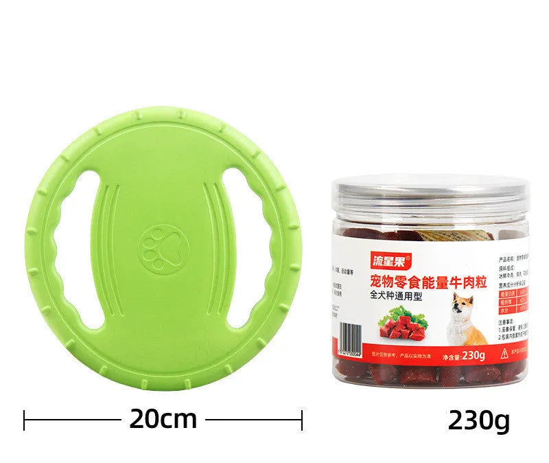 Dog training set with plastic frisbee and bite ring in orange and green colours on grass
