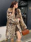 A long faux fur street fashion coat with a fur collar and pockets, shown in an urban setting.
