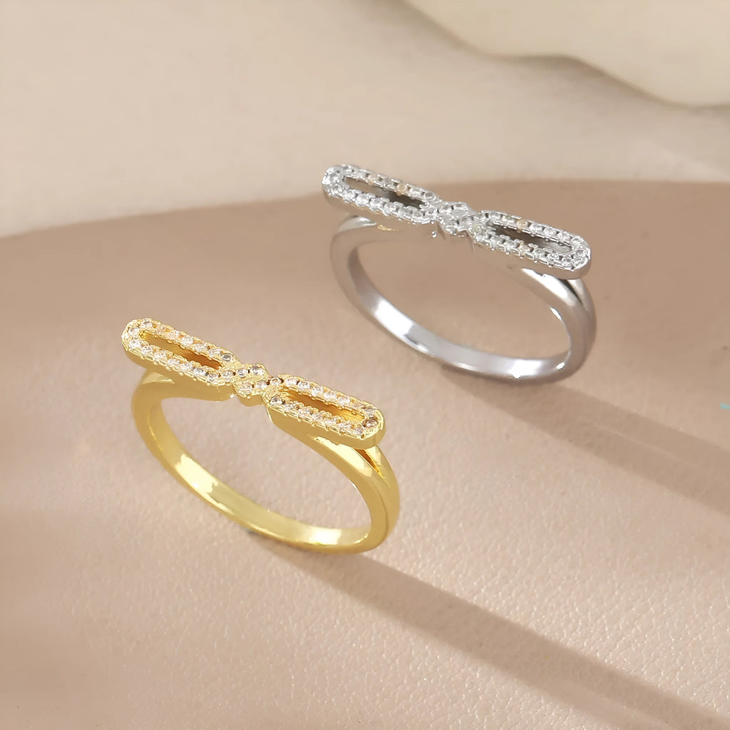 Fashion bowknot ring for women, copper with electroplated gold finish, bow shape on white background