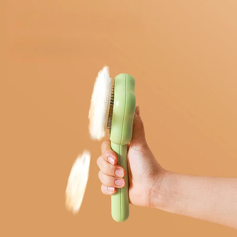 Green self-cleaning cat comb with stainless steel needles measuring 20 cm long
