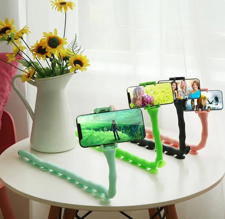 Flexible black rubber phone holder with suction cup wrapped around a bicycle handlebar, showing a phone mounted at an angle.