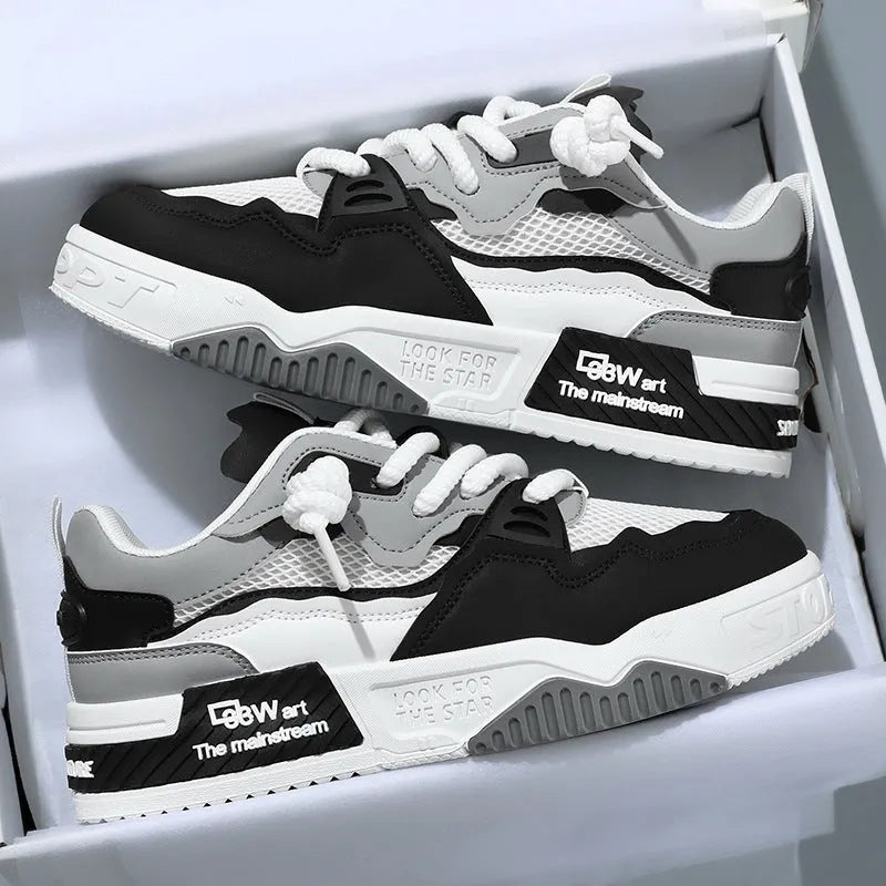 Men's low-top white board shoes with soft rubber sole and mesh lining on a plain background.