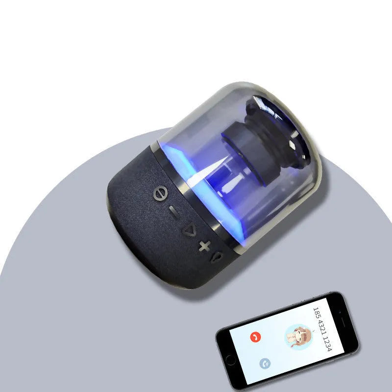 Black wireless Bluetooth speaker with touch controls, showcasing its compact design and 360-degree sound output.