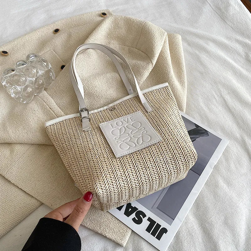 Straw woven women's shoulder bag in black with three-dimensional pocket and 27cm width