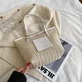 Straw woven women's shoulder bag in black with three-dimensional pocket and 27cm width