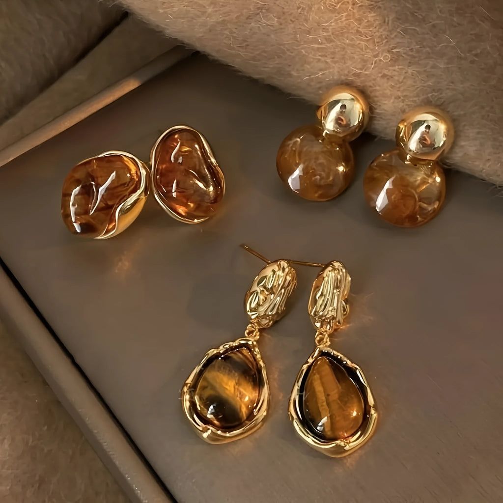 Handmade alloy earrings set showing three geometric designs: irregular amber, wafer disc and water drop tigereye styles