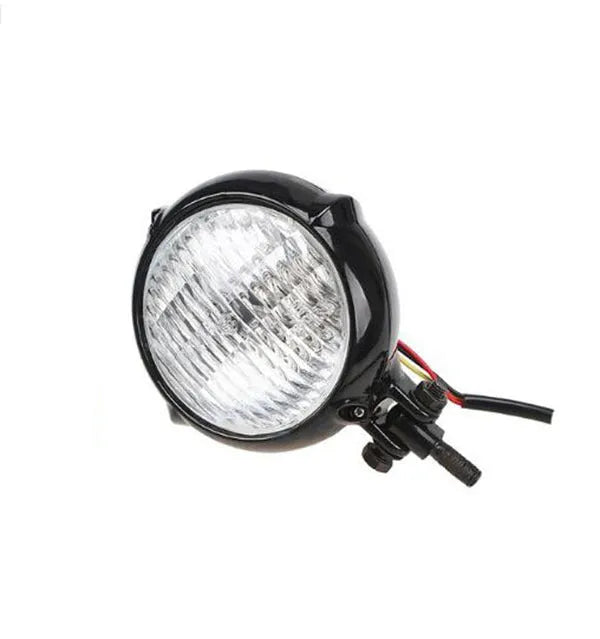 Black electroplated Harley-style halogen headlight with an 8 cm diameter lens.
